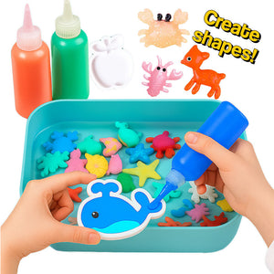 Children using Magic Gel craft kit to create colorful sea creature shapes in a blue tray with squeeze bottles of gel