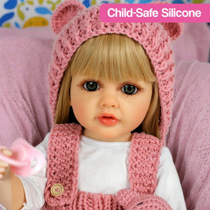 Lifelike real-feel baby doll with blonde hair, child-safe silicone, and pink knitted outfit holding pacifier