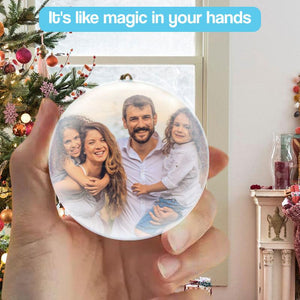 3D holographic video memory ball glowing on wooden surface with Christmas tree background