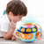Infant playing with colorful music projection hand-pat drum educational toy designed for early development and sensory play.