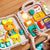 Busy Board Montessori educational toy with interactive buttons, flashing lights, and safe plastic design for infants aged 1-3 years.
