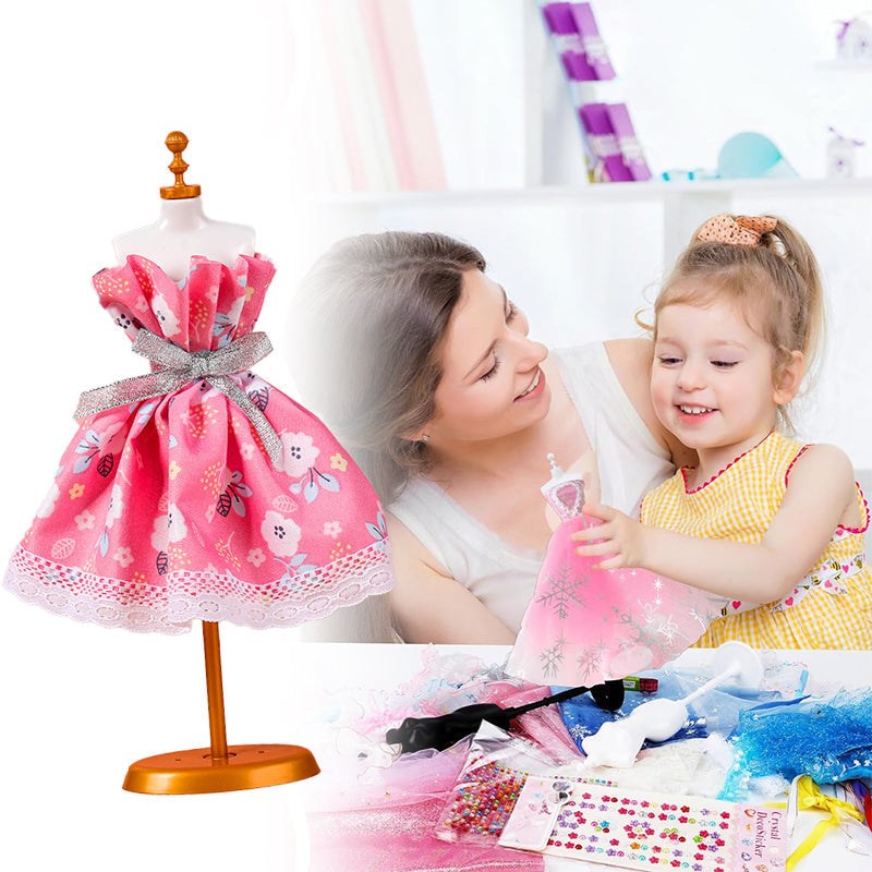 Child and mother using a fashion design studio kit with a pink floral fabric dress on a mannequin and assorted craft supplies on the table